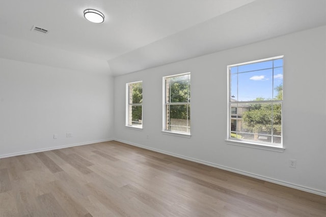 1816 Melissa Oaks Ln, Austin, TX 78744 - spare room featuring light wood-type flooring, baseboards, and lofted ceiling