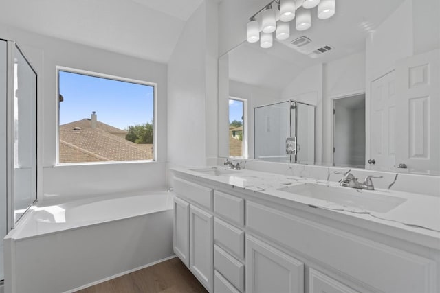 1816 Melissa Oaks Ln, Austin, TX 78744 - full bath with lofted ceiling, wood finished floors, a stall shower, a bath, and double vanity