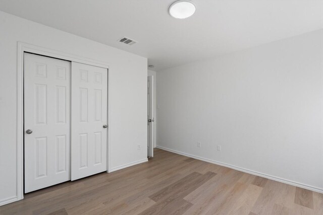 1816 Melissa Oaks Ln, Austin, TX 78744 - unfurnished bedroom with wood finished floors, baseboards, and a closet