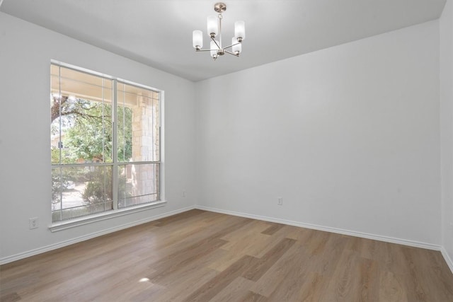 1816 Melissa Oaks Ln, Austin, TX 78744 - unfurnished room with a chandelier, wood finished floors, and baseboards