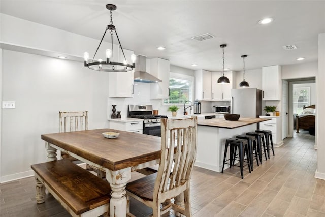 5530 US Highway 90a W, Shiner, TX 77984 - dining room with a chandelier, light wood-style floors, recessed lighting, and baseboards
