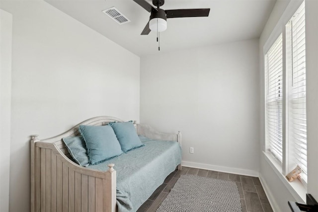 5530 US Highway 90a W, Shiner, TX 77984 - bedroom featuring wood finish floors, baseboards, and a ceiling fan