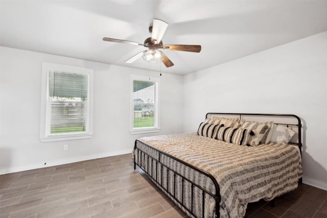 5530 US Highway 90a W, Shiner, TX 77984 - bedroom featuring baseboards, wood finished floors, and a ceiling fan