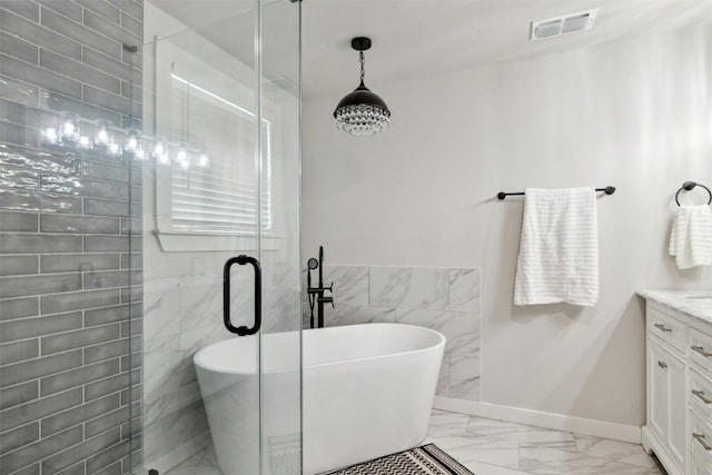 5530 US Highway 90a W, Shiner, TX 77984 - full bathroom featuring marble look tile flooring, tile walls, vanity, a freestanding tub, and a stall shower