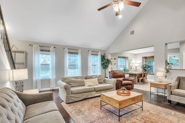 living room featuring a ceiling fan, high vaulted ceiling, wood finished floors, and baseboards