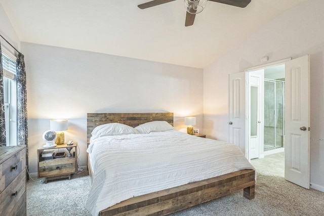 bedroom with carpet flooring, lofted ceiling, connected bathroom, a ceiling fan, and baseboards