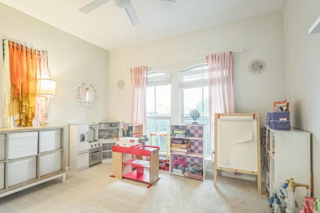 rec room with ceiling fan and light colored carpet