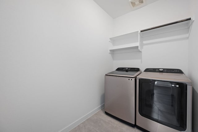 2324 Sawdust Dr, Georgetown, TX 78633 - clothes washing area with washing machine and dryer, baseboards, and light tile patterned floors