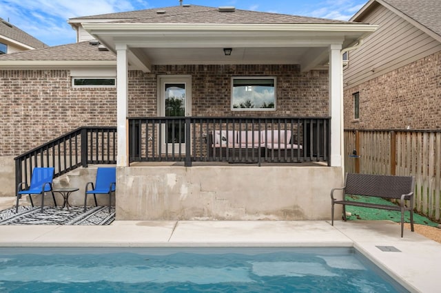 2324 Sawdust Dr, Georgetown, TX 78633 - rear view of house with an outdoor pool, brick siding, fence, and a shingled roof