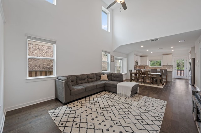 2324 Sawdust Dr, Georgetown, TX 78633 - living area with ceiling fan, dark wood-style floors, plenty of natural light, and a towering ceiling