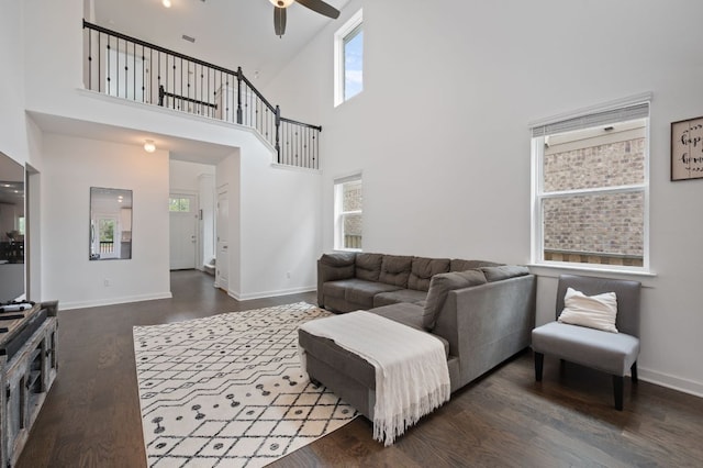 2324 Sawdust Dr, Georgetown, TX 78633 - living area with a ceiling fan, dark wood-style floors, a towering ceiling, and baseboards