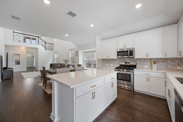 2324 Sawdust Dr, Georgetown, TX 78633 - kitchen featuring appliances with stainless steel finishes, open floor plan, backsplash, a center island, and recessed lighting