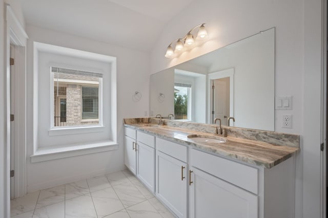 2324 Sawdust Dr, Georgetown, TX 78633 - full bath featuring marble look tile flooring, lofted ceiling, and double vanity