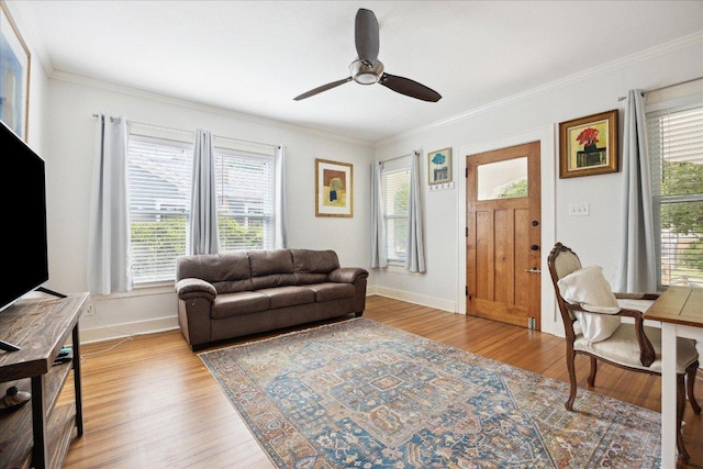 400 E 34th St, Austin, TX 78705 - living room with ornamental molding, wood finished floors, ceiling fan, and baseboards