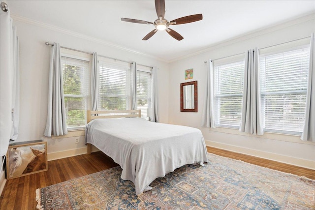400 E 34th St, Austin, TX 78705 - bedroom with baseboards, crown molding, multiple windows, and wood finished floors