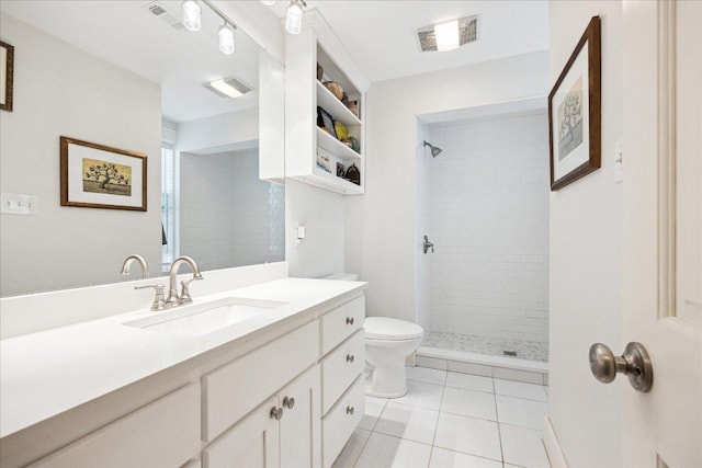 400 E 34th St, Austin, TX 78705 - bathroom featuring toilet, vanity, a tile shower, and tile patterned flooring