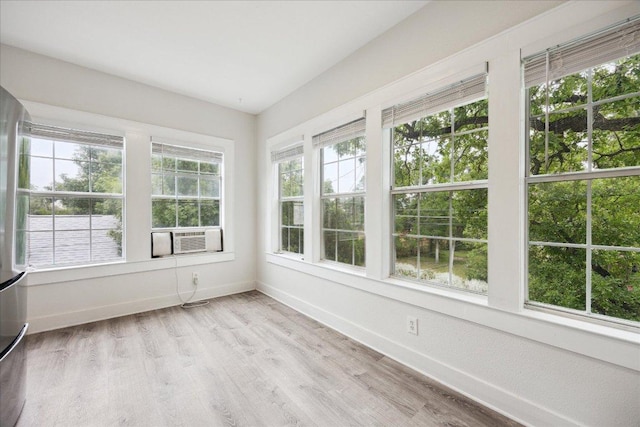 400 E 34th St, Austin, TX 78705 - unfurnished sunroom featuring baseboards, cooling unit, and wood finished floors
