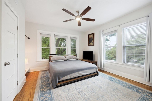 400 E 34th St, Austin, TX 78705 - bedroom featuring baseboards, wood finished floors, and ceiling fan
