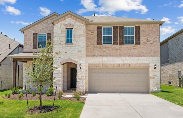 16804 Santiaguillo Trce, Manor, TX 78653 - view of front of property with stone siding, concrete driveway, an attached garage, and brick siding