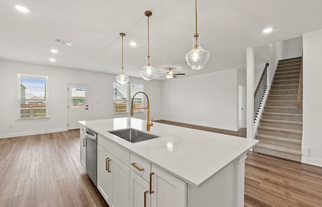 16804 Santiaguillo Trce, Manor, TX 78653 - kitchen featuring wood finished floors, dishwasher, open floor plan, plenty of natural light, and recessed lighting