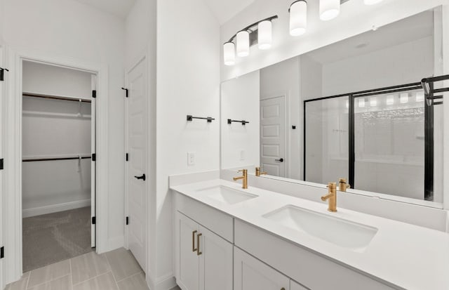 16804 Santiaguillo Trce, Manor, TX 78653 - bathroom with a stall shower, double vanity, and a spacious closet