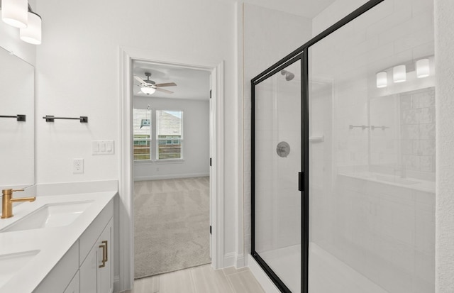 16804 Santiaguillo Trce, Manor, TX 78653 - full bathroom with double vanity, a ceiling fan, and a stall shower
