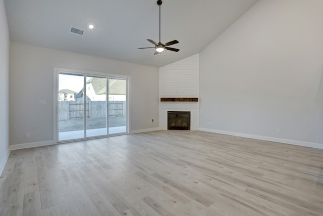 17212 Autumn Falls Dr, Manor, TX 78653 - unfurnished living room with ceiling fan, high vaulted ceiling, light wood-type flooring, baseboards, and a large fireplace