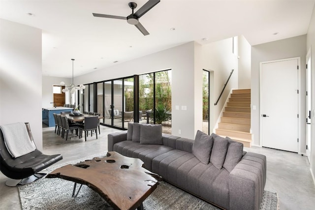 404 W Milton St, Austin, TX 78704 - living room with finished concrete flooring, a chandelier, stairs, and ceiling fan
