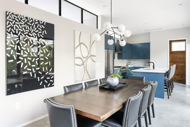 404 W Milton St, Austin, TX 78704 - dining room with concrete flooring and a chandelier