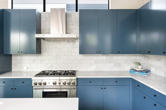 404 W Milton St, Austin, TX 78704 - kitchen with high end stainless steel range, blue cabinets, wall chimney exhaust hood, and light countertops