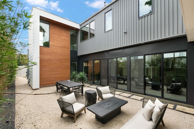 404 W Milton St, Austin, TX 78704 - rear view of property with a patio, board and batten siding, and outdoor dining area
