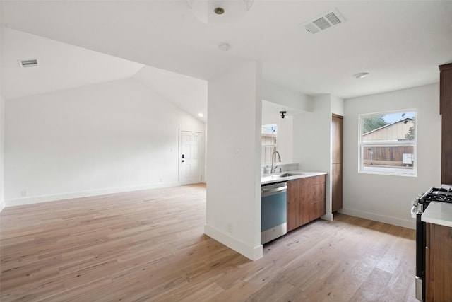 1800 Nicole Cir, Round Rock, TX 78664 - kitchen featuring dishwasher, a sink, light countertops, black range with gas stovetop, and light wood-style floors