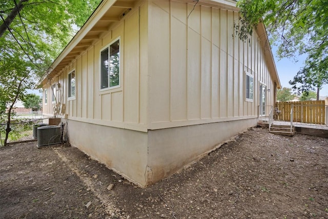1800 Nicole Cir, Round Rock, TX 78664 - view of home's exterior with board and batten siding, central AC, and a deck