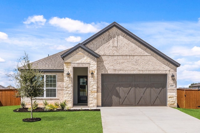 106 Nandina Path, Bastrop, TX 78602 - view of front of house with stone siding, driveway, a garage, and a shingled roof
