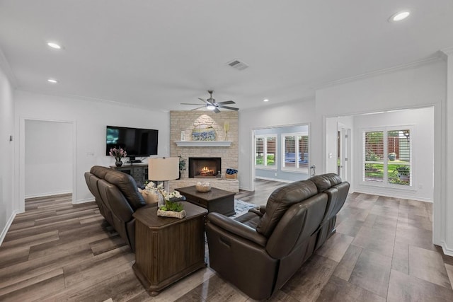 906 Texas Trl, Austin, TX 78737 - living room with ceiling fan, a stone fireplace, crown molding, wood finished floors, and recessed lighting