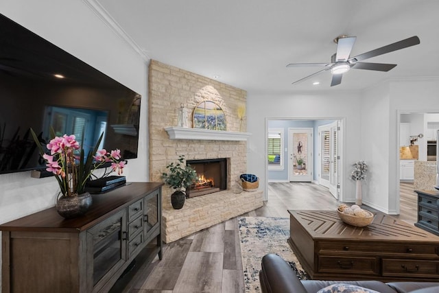 906 Texas Trl, Austin, TX 78737 - living room with wood finished floors, ceiling fan, ornamental molding, a fireplace, and recessed lighting