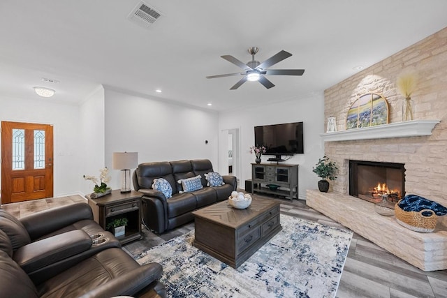 906 Texas Trl, Austin, TX 78737 - living room with ceiling fan, a stone fireplace, recessed lighting, and wood finished floors
