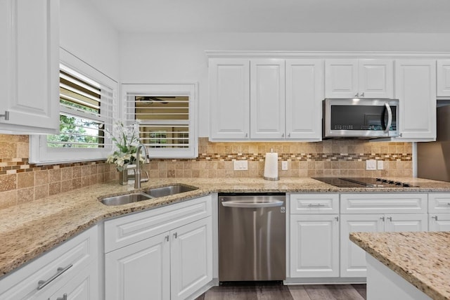 906 Texas Trl, Austin, TX 78737 - kitchen with appliances with stainless steel finishes, a sink, white cabinets, and tasteful backsplash