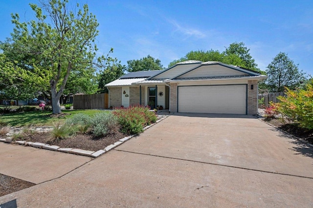 11707 Ruffed Grouse Dr, Austin, TX 78758 - ranch-style house with a garage, brick siding, roof mounted solar panels, and concrete driveway