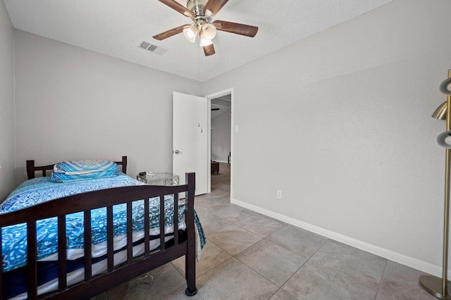 11707 Ruffed Grouse Dr, Austin, TX 78758 - tiled bedroom with a textured ceiling and ceiling fan