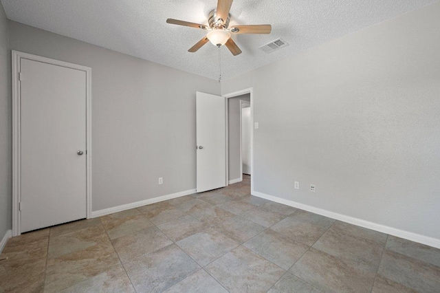 11707 Ruffed Grouse Dr, Austin, TX 78758 - unfurnished bedroom featuring a textured ceiling and a ceiling fan