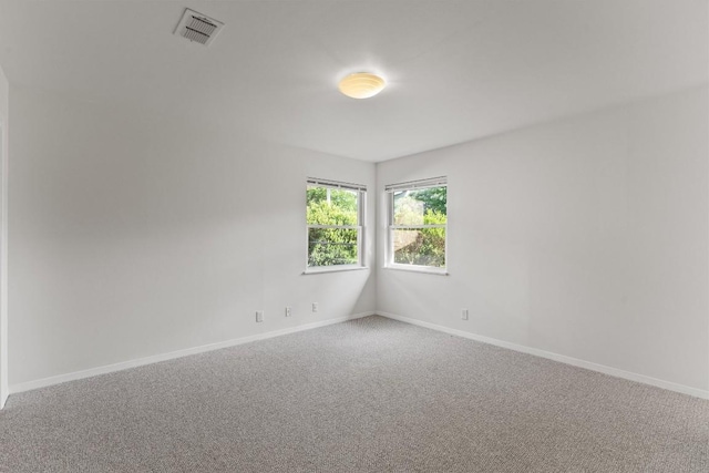 unfurnished room featuring carpet floors and baseboards