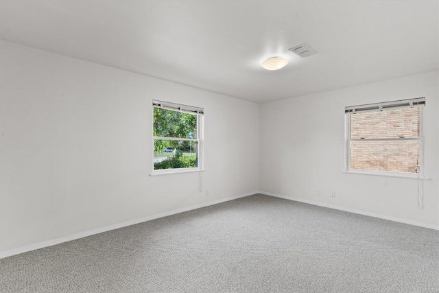 carpeted empty room with baseboards