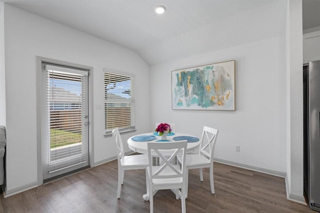 dining room featuring vaulted ceiling, wood finished floors, baseboards, and recessed lighting
