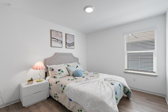 bedroom with wood finished floors and baseboards