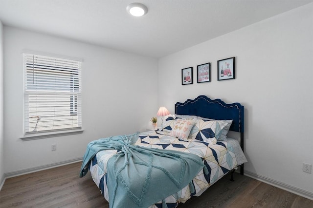 bedroom with wood finished floors and baseboards