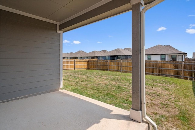 view of yard featuring a patio area and a residential view