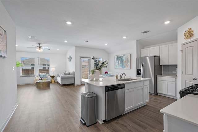 kitchen with appliances with stainless steel finishes, a sink, dark wood-style floors, light countertops, and a ceiling fan