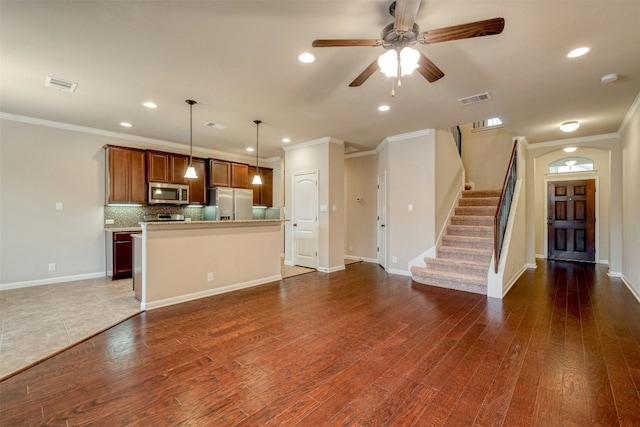 14001 Avery Ranch Blvd Unit 1103, Austin, TX 78717 - kitchen featuring appliances with stainless steel finishes, ornamental molding, wood finished floors, tasteful backsplash, and a kitchen island