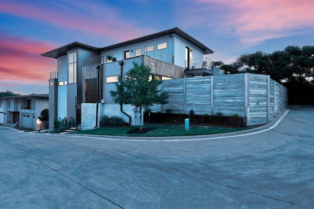 property at dusk with fence